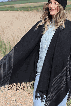 Picture of Pom Black Wrap Poncho with striped border and tassels